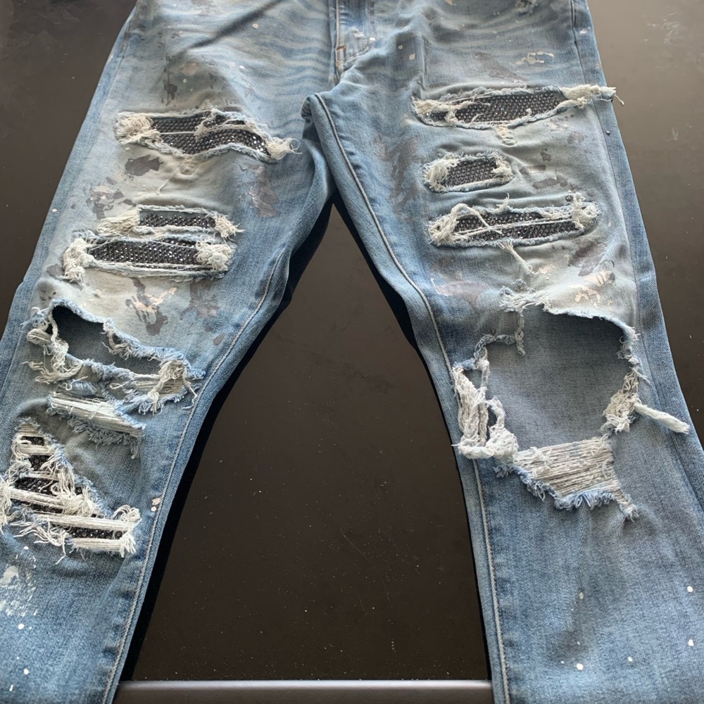 AMIRI Light Blue Distressed Skinny Jeans with Patch Detailing